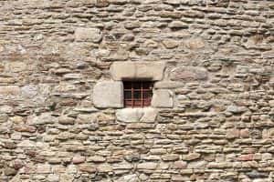 Prison wall with grilled window of cell