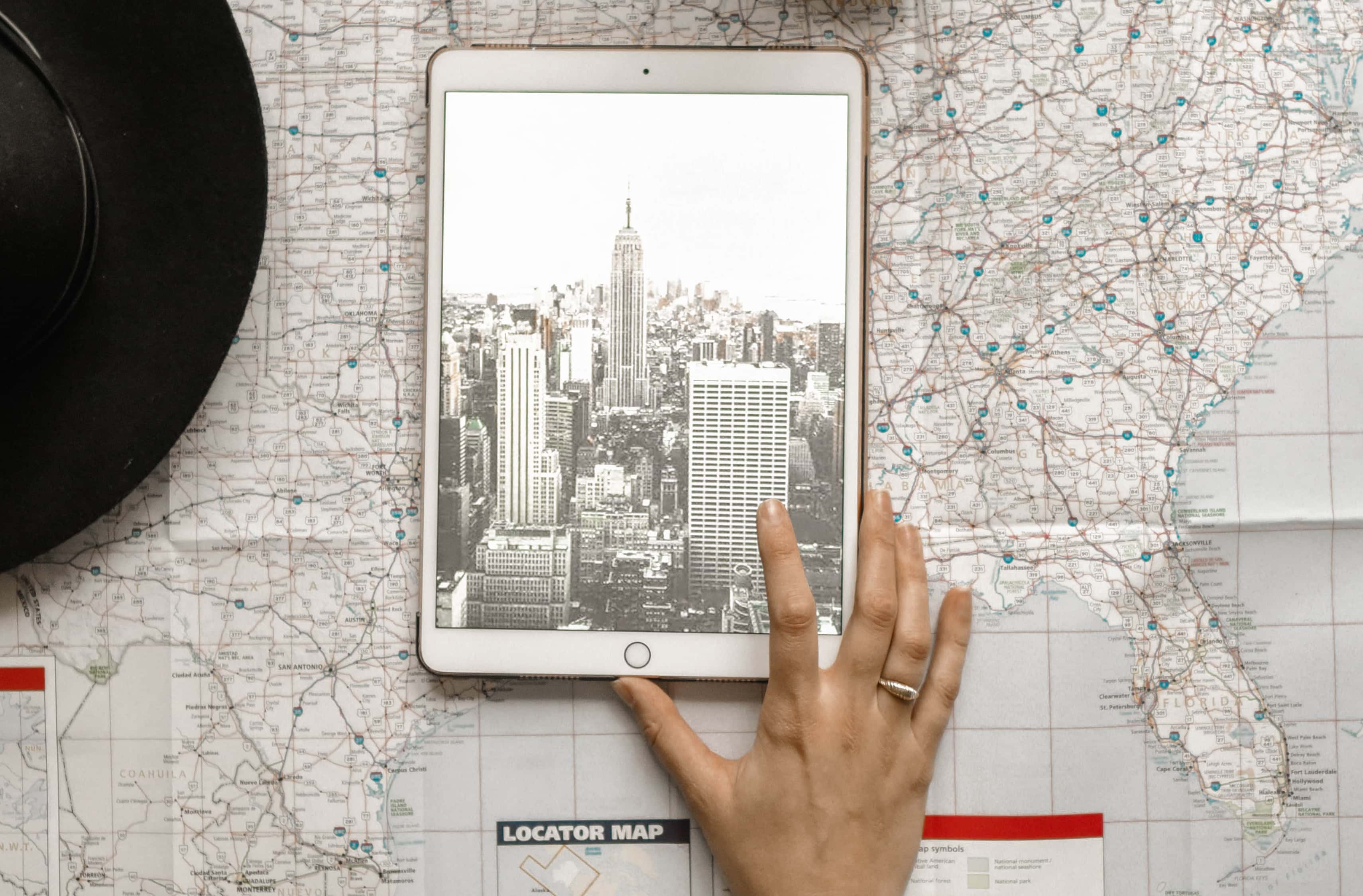 Photo: hat, ipad and map