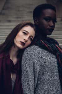 Two women leaning on each other