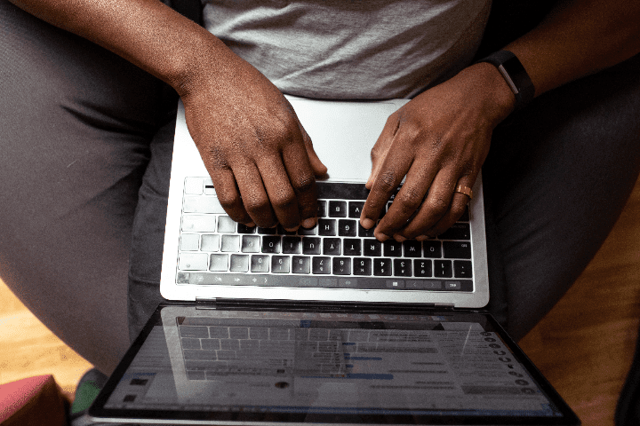 man typing on a laptop