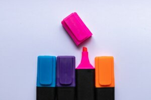 Row of highlighter pens with one with it's lid off