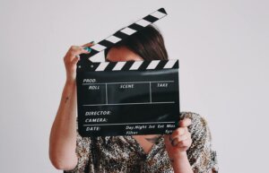 Woman holding a film clapperboard