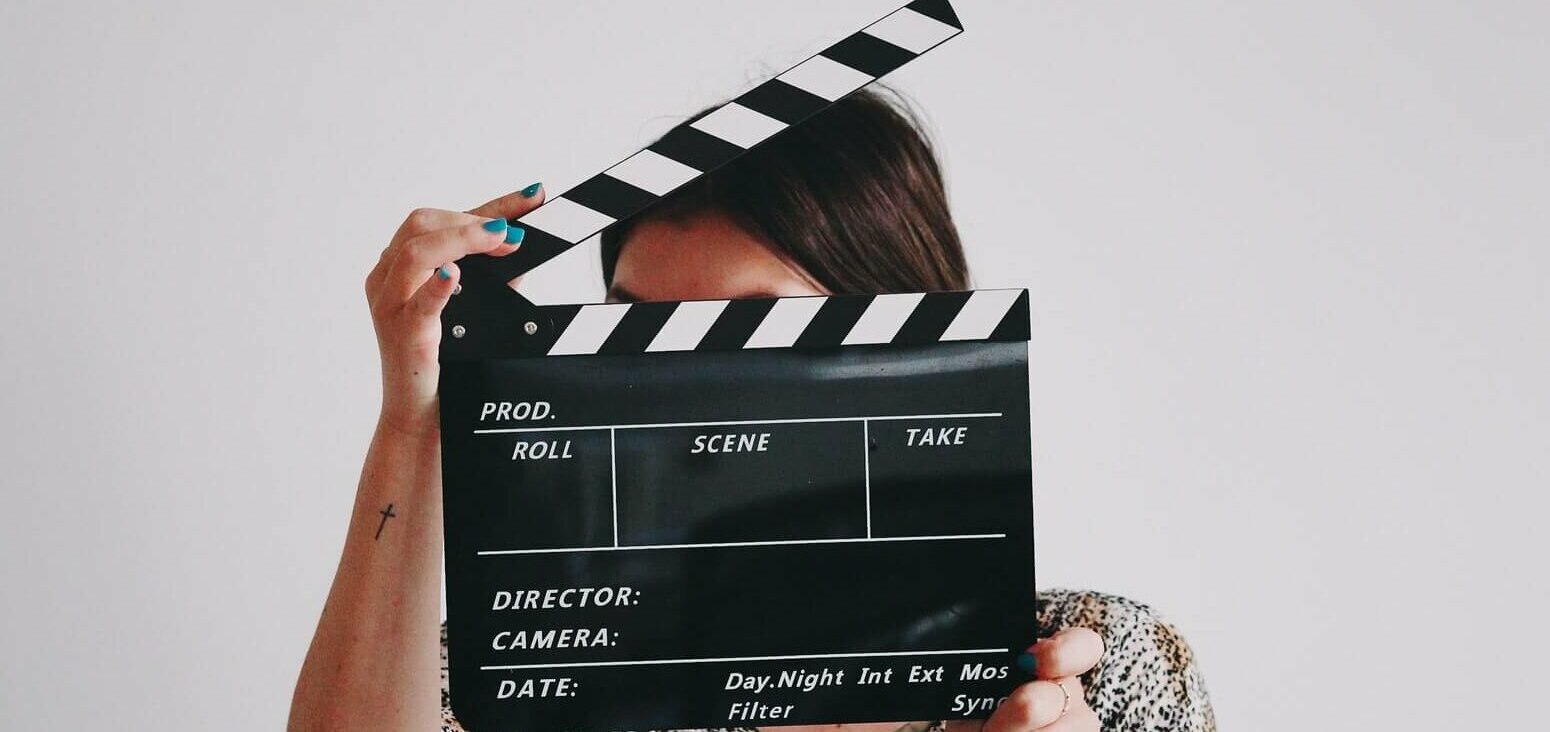 Woman holding a film clapperboard