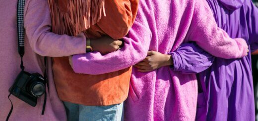 view of women linking arms together.