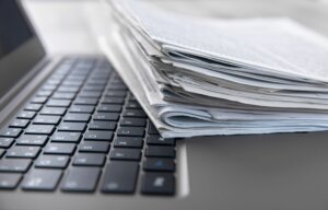 laptop keyboard with papers
