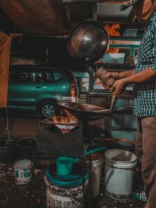 a street vendor cooking in a wok